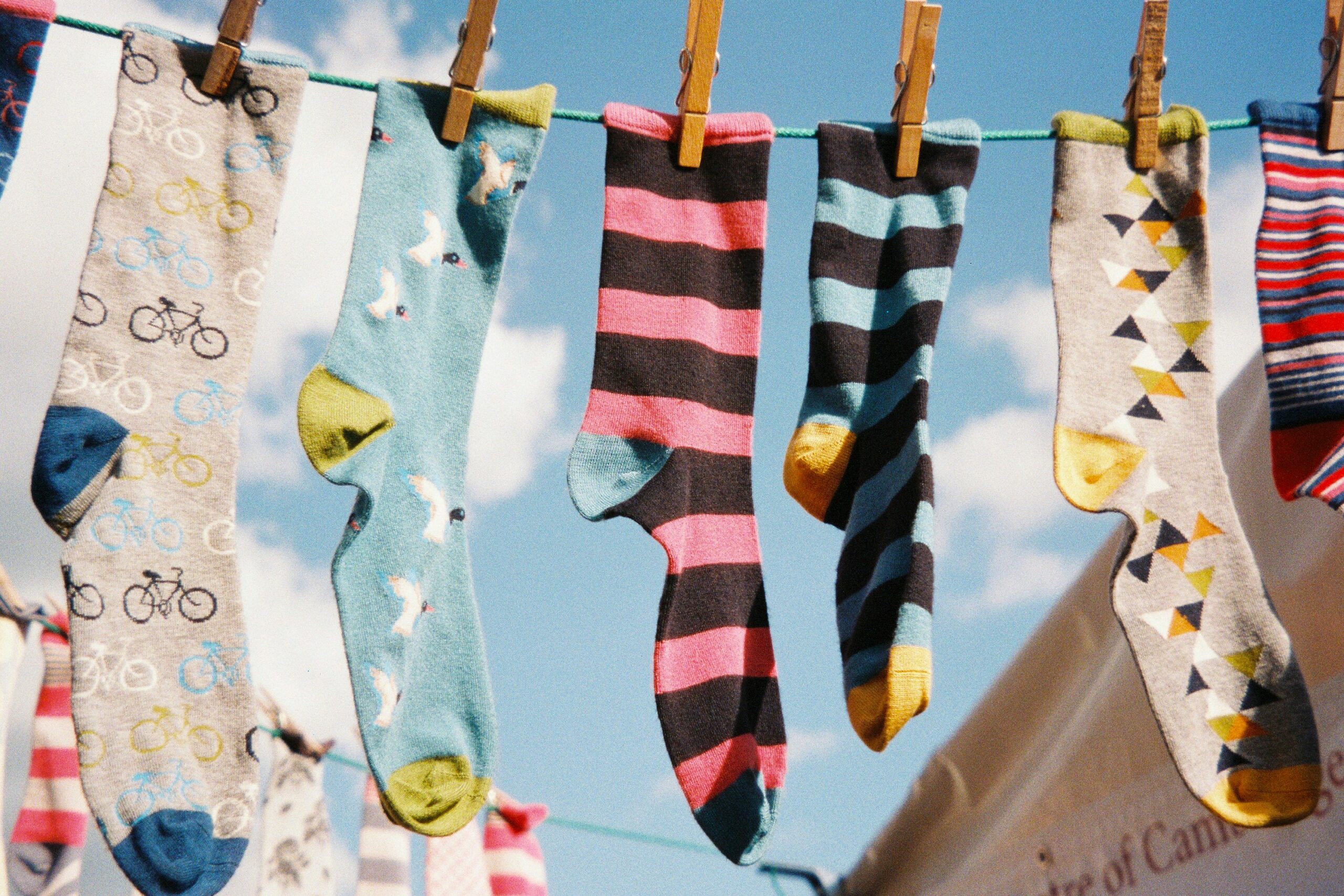 Different patterned socks hanging on a clothesline