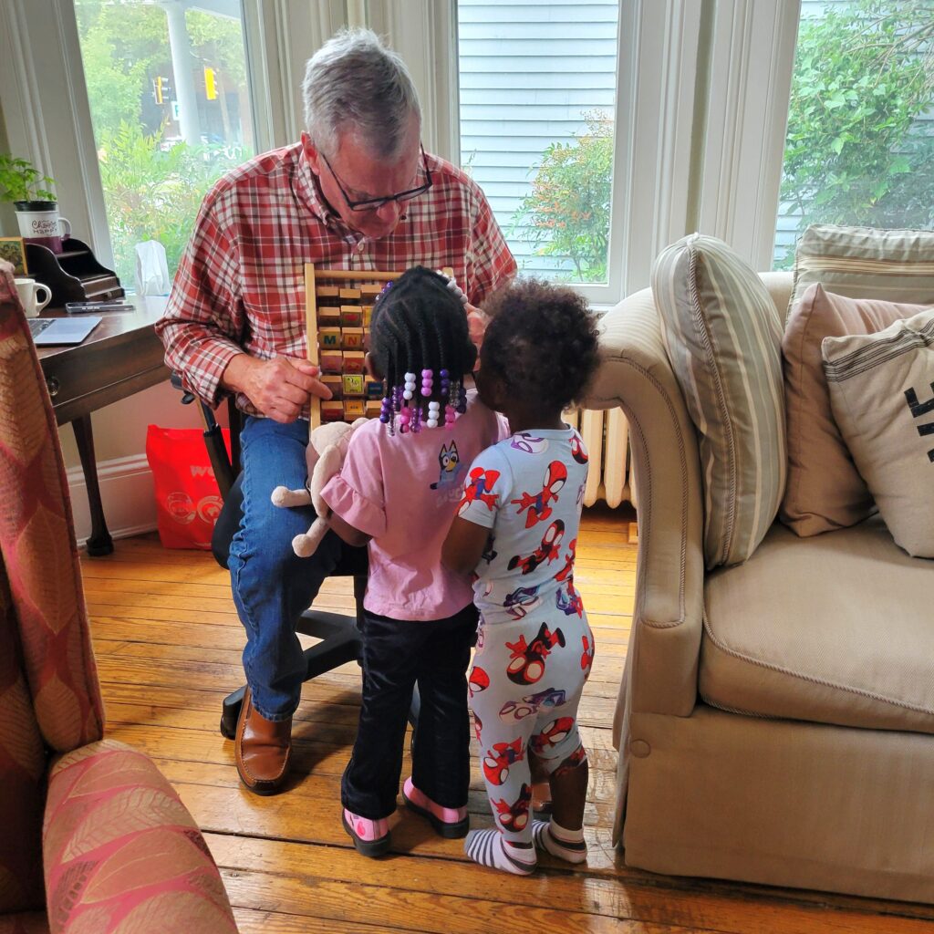 Volunteer playing with kids at Easton's Promise